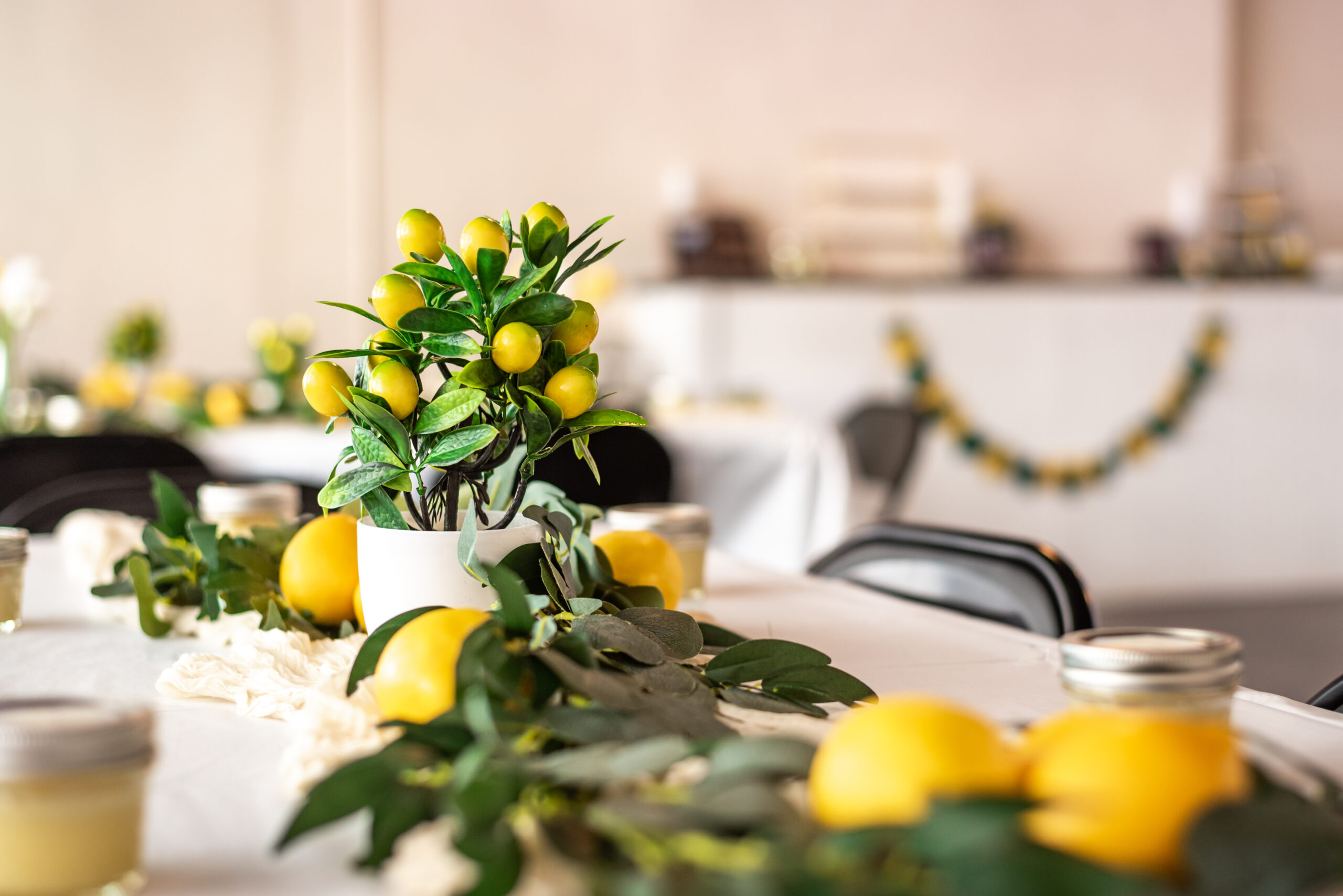 Image shows The Magnolia Room's party space decorated with lemons and greenery. The style is polished and fun.